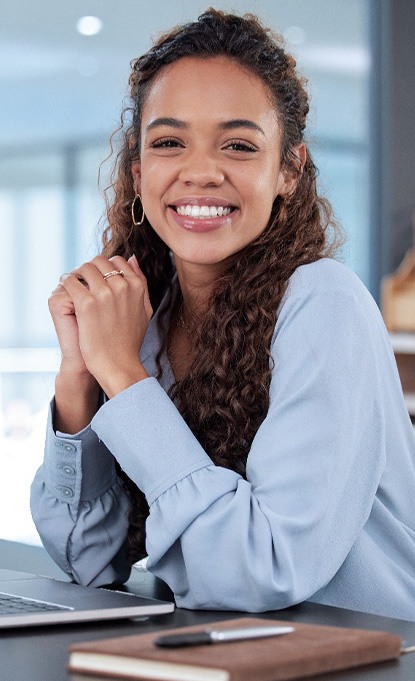 Woman smiling while sitting in office