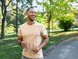 Man smiling while jogging outside
