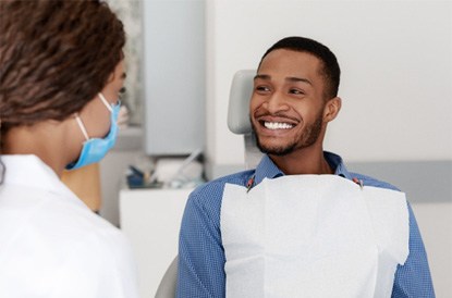 a patient at his dental appointment in Denver, CO