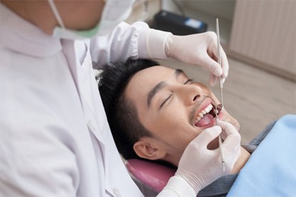 a patient at his dental appointment in Denver, CO