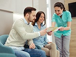 dental assistant showing a brochure to patients