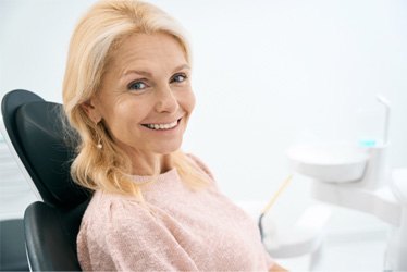 Woman smiling with dental crowns in Denver