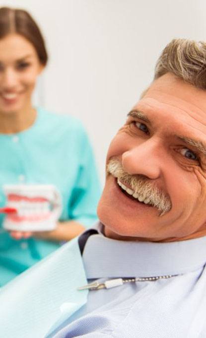 senior man at a consultation for dentures 