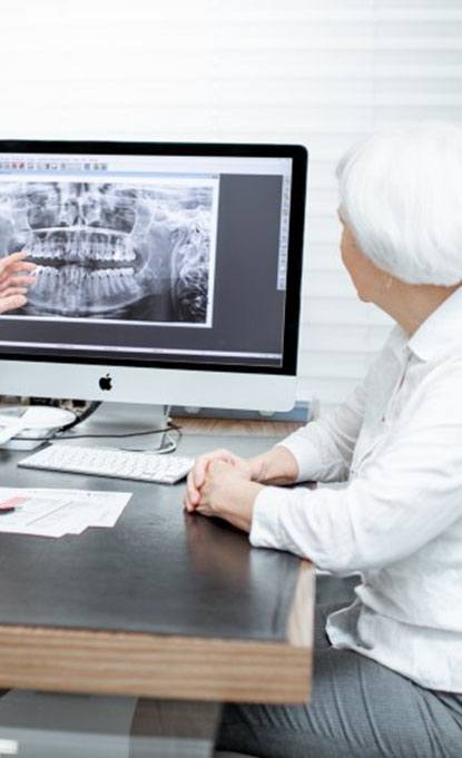 dentist showing a patient their X-rays 