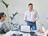 a man with dentures speaking with colleagues