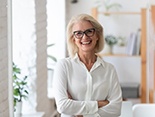 a mature woman smiling with new dentures