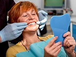 Woman in dentist’s chair for dentures