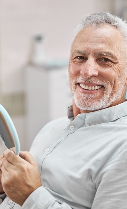 patient smiling after getting dentures