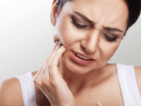 Woman with toothache holding cheek