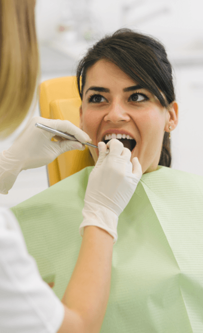 Woman receiving dental checkup to prevent dental emergencies