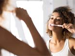 young woman brushing teeth