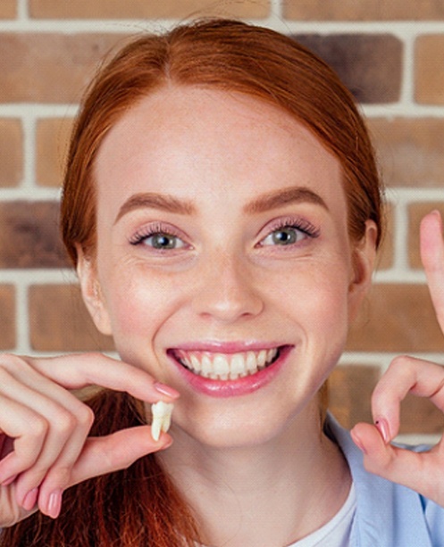 Woman smiling after tooth extraction in Denver