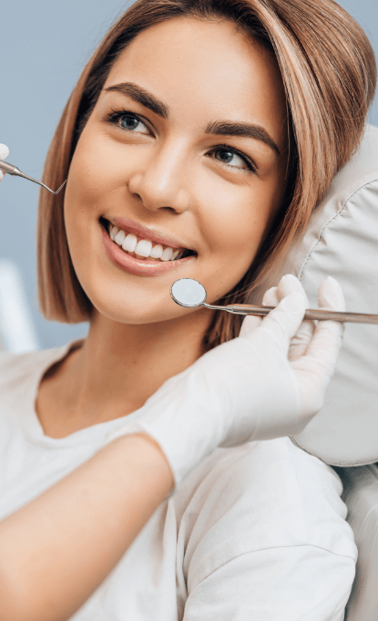 Woman smiling during dental checkup and teeth cleaning visit