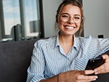 Woman with glasses and dental implants in Denver, CO