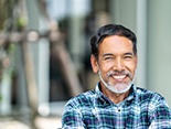 Man with patterned shirt and dental implants in Denver, CO