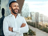 Man with dental implants in Denver, CO with arms crossed