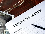Dental insurance form on desk with glasses