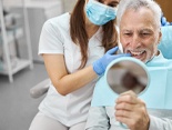 patient smiling after getting dental implants in Denver