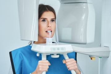 Woman getting cone beam scan of her mouth and jaw in dental office