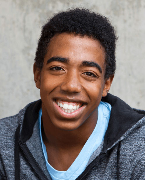 Young man with healthy smile after orthodontic treatment