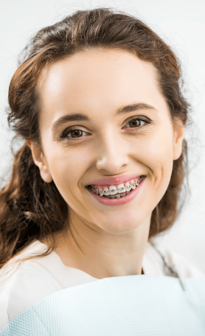 Woman with traditional braces smiling