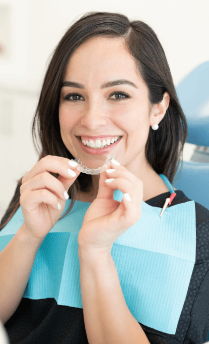 Woman placing Invisalign tray