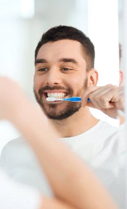 man brushing his teeth