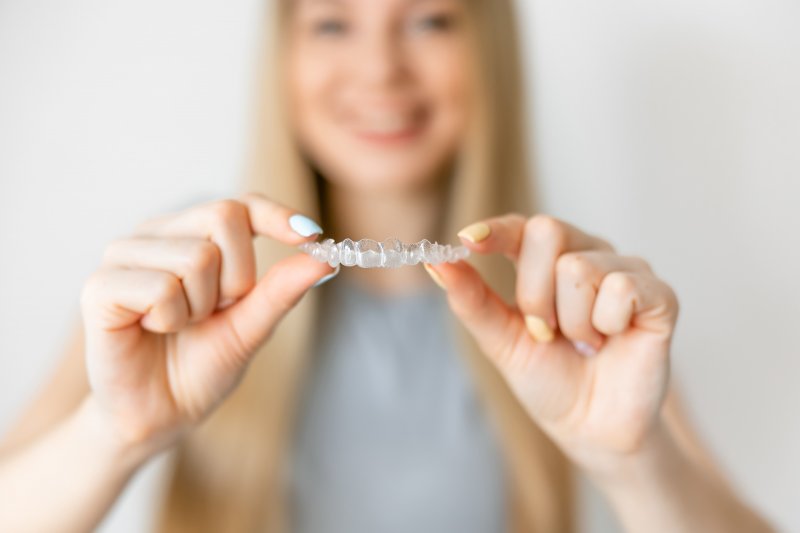 woman holding Invisalign try in Denver
