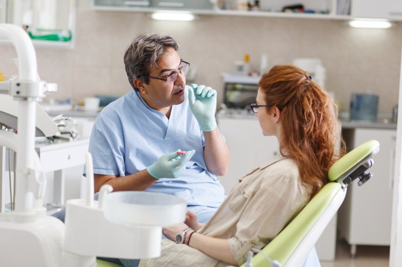 A dentist explaining dental implant success rates