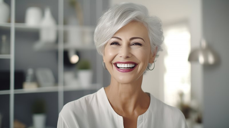 Older woman smiling with cosmetic dentistry treatments